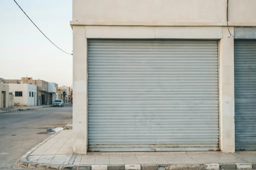 Large aluminum rolling shutter door installed on a commercial shopfront in Kuwait
